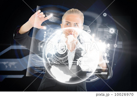 Blonde businesswoman touching interface with earth 10026970