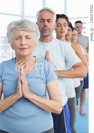 Sporty people with eyes closed and joined hands Sporty people with eyes closed and joined hands 10027482