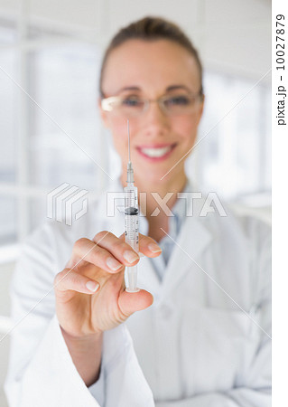 Female doctor holding an injection in hospital Female doctor holding an injection in hospital 10027879
