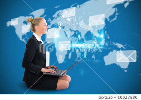 Blonde businesswoman sitting using laptop with earth interface Blonde businesswoman sitting using laptop with earth interface 10027880