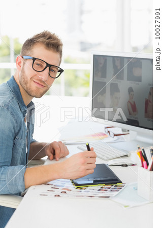 Handsome editor working with digitizer looking at camera 10027991