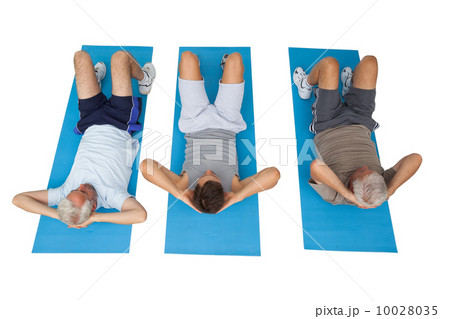 Full length of three men doing abdominal crunches Full length of three men doing abdominal crunches 10028035