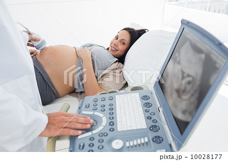 Doctor operating ultrasound machine Doctor operating ultrasound machine 10028177