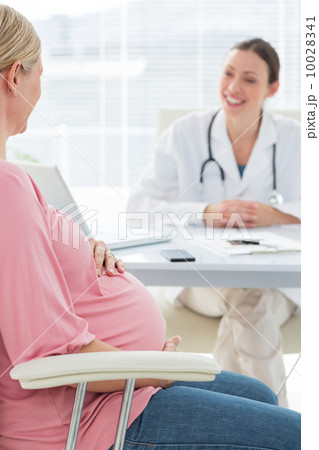 Pregnant woman consulting female doctor Pregnant woman consulting female doctor 10028341
