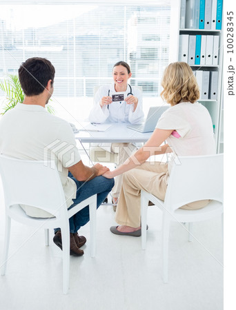 Expectant couple consulting gynaecologist Expectant couple consulting gynaecologist 10028345