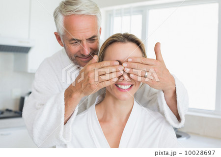 Happy man covering his partners eyes in the morning 10028697