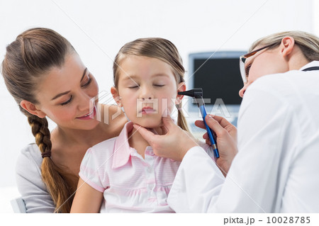 Girl being examined by doctor with otoscope 10028785