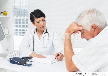 Doctor explaining reports to worried senior patient 10028895