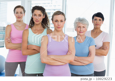 Confident women with arms crossed in yoga class 10029223