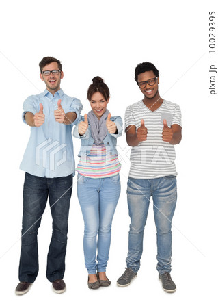 Portrait of three happy friends gesturing thumbs up 10029395