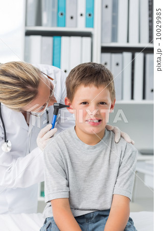 Boy being examined by pediatrician with otoscope 10029985