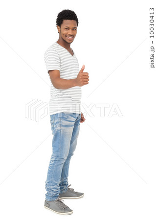 Portrait of a happy young man gesturing thumbs up Portrait of a happy young man gesturing thumbs up 10030413