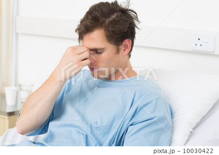 Patient suffering from headache relaxing in hospital 10030422