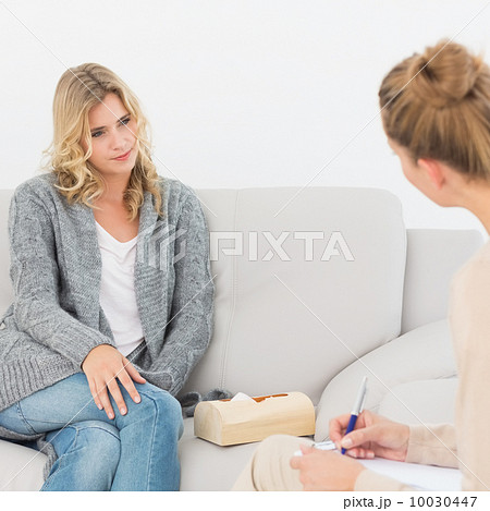 Blonde woman listening to her therapist 10030447