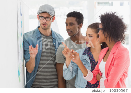 Artists in discussion in front of whiteboard 10030567