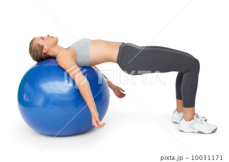 Fit young woman exercising with fitness ball 10031171