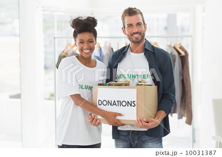 Smiling young couple with clothes donation 10031387
