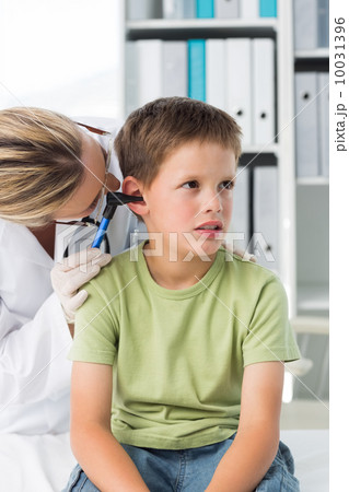 Boy being examined by female doctor Boy being examined by female doctor 10031396