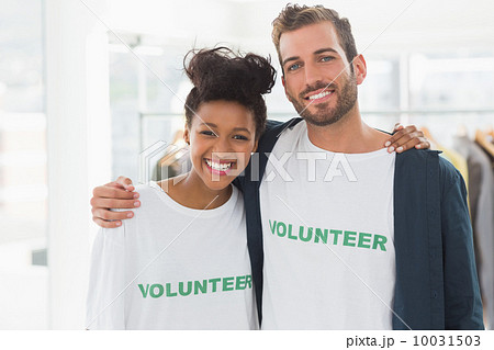 Portrait of two young volunteers with arms around 10031503