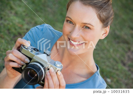 Beautiful female photographer at park 10031635