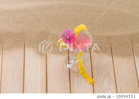 Fresh pink cocktail at the beach Fresh pink cocktail at the beach 10034551