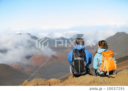 Hiking - hikers sitting enjoying view on volcano Hiking - hikers sitting enjoying view on volcano 10037291