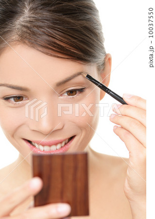 Makeup girl putting eyebrow color in mirror Makeup girl putting eyebrow color in mirror 10037550