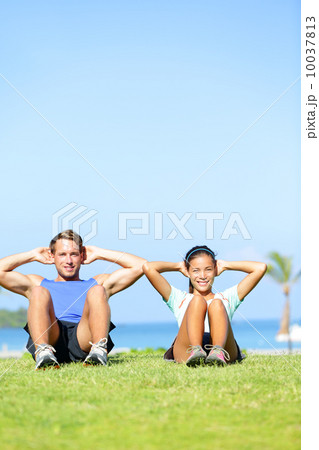 People exercising - Couple doing sit ups outdoors People exercising - Couple doing sit ups outdoors 10037813