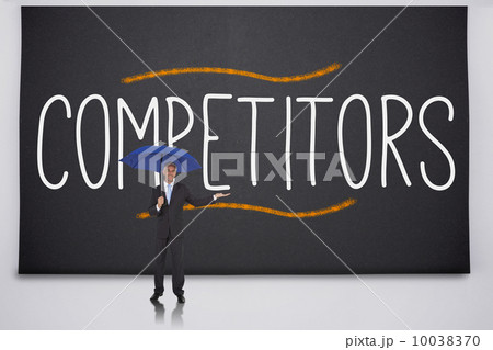 Businessman holding umbrella against the word competitors 10038370