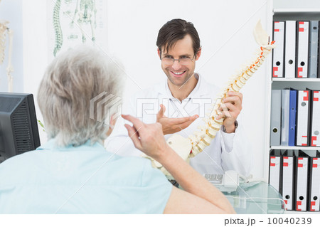 Friendly doctor explaining spine to a senior patient 10040239