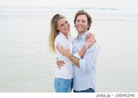 Happy romantic couple embracing at beach 10040240