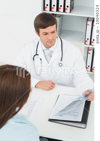 Doctor in conversation with female patient in medical office 10040324