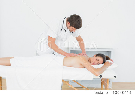 Male physiotherapist massaging woman's back Male physiotherapist massaging woman's back 10040414