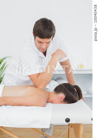 Male physiotherapist massaging woman's back Male physiotherapist massaging woman's back 10040438