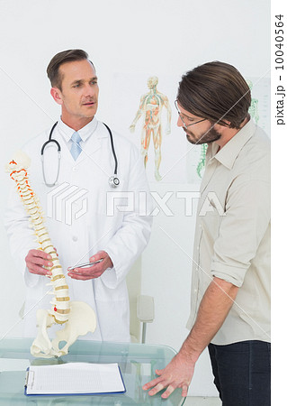 Male doctor explaining the spine to a patient 10040564