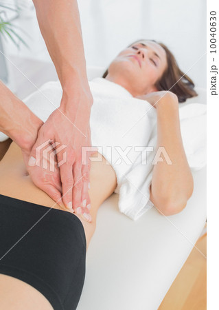 Close-up of a physiotherapist massaging woman's body 10040630