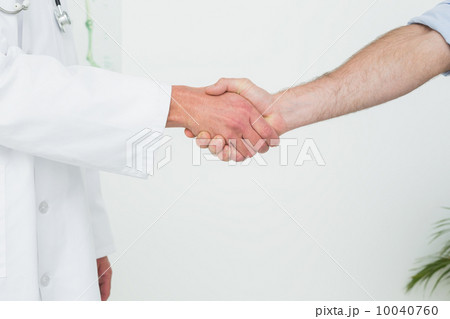 Close-up of a doctor and patient shaking hands Close-up of a doctor and patient shaking hands 10040760