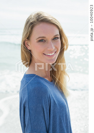 Portrait of a smiling casual woman at beach 10040923
