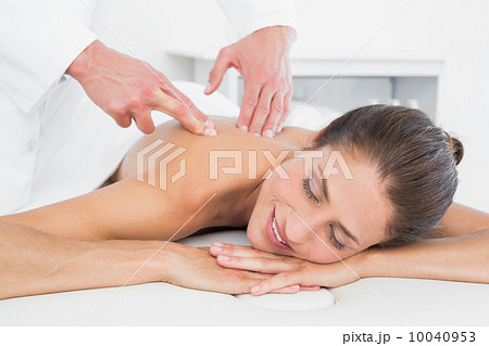 Male physiotherapist massaging woman's back 10040953