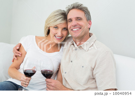 Happy couple with wine glasses at home 10040954