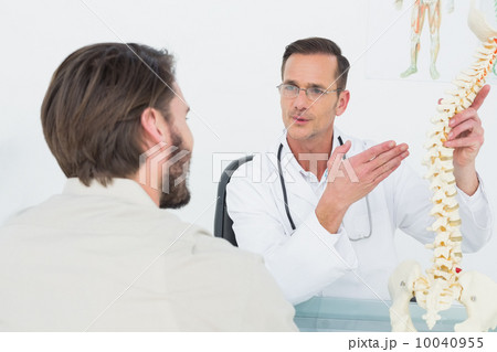 Male doctor explaining the spine to a patient 10040955