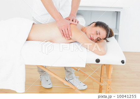 Male physiotherapist massaging woman's back Male physiotherapist massaging woman's back 10041255