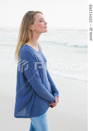 Peaceful woman with eyes closed at beach Peaceful woman with eyes closed at beach 10041268