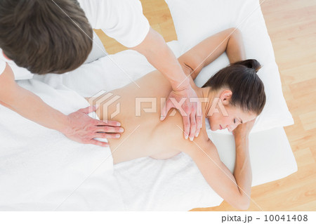Male physiotherapist massaging woman's back Male physiotherapist massaging woman's back 10041408