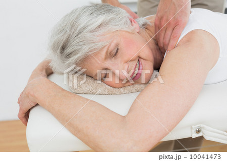 Physiotherapist massaging a senior woman's shoulder Physiotherapist massaging a senior woman's shoulder 10041473