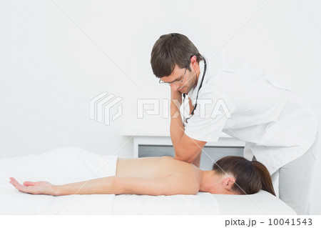 Male physiotherapist massaging woman's back Male physiotherapist massaging woman's back 10041543