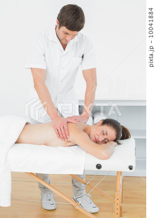 Male physiotherapist massaging woman's back Male physiotherapist massaging woman's back 10041884