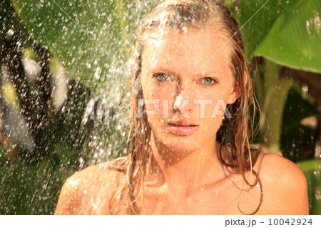 woman in tropical shower palms around 10042924