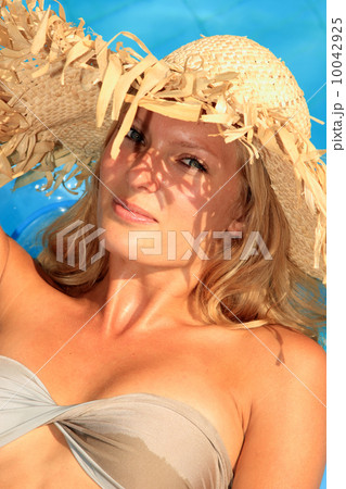 Young woman enjoying a swimming pool Young woman enjoying a swimming pool 10042925