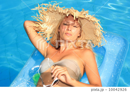 Young woman enjoying a swimming pool 10042926
